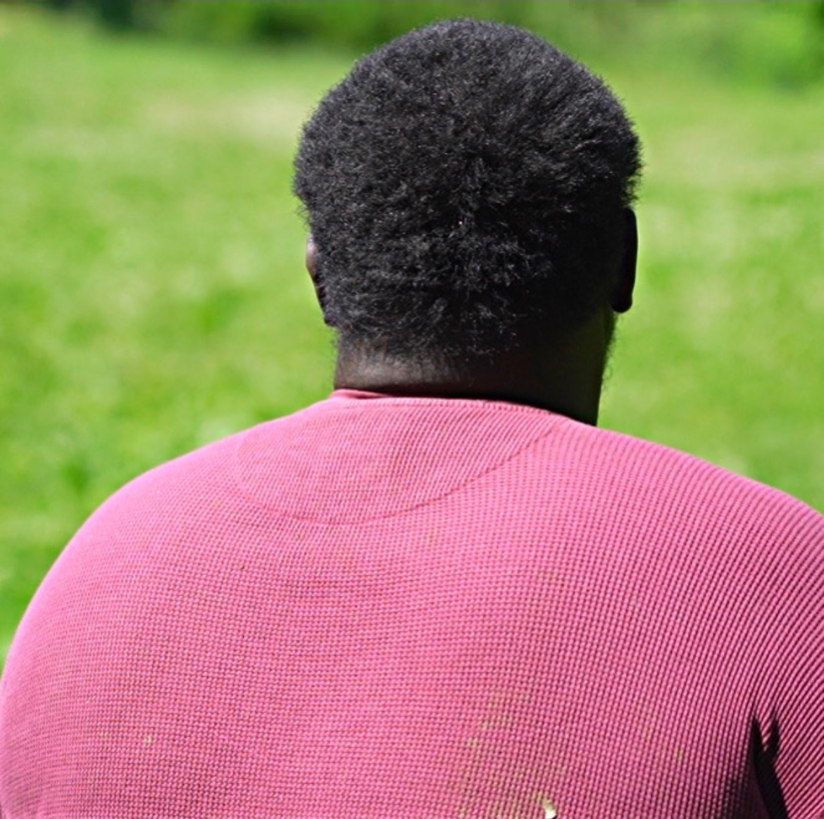 Charles M. Daniel seen from behind in a field
