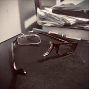 Broken eyeglasses on a dark surface